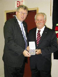 U.S. Rep. Frank Lucas presents the Silver Star to Maj. John Mullins, of Mountain Park, during a ceremony Monday in Snyder.